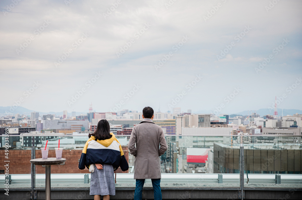 Fototapeta premium partners looking far away on the roof of Hakata JR station, Kyushu, Japan