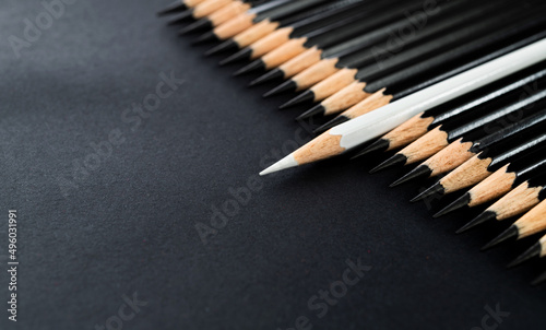 White pencil standing out from the crowd