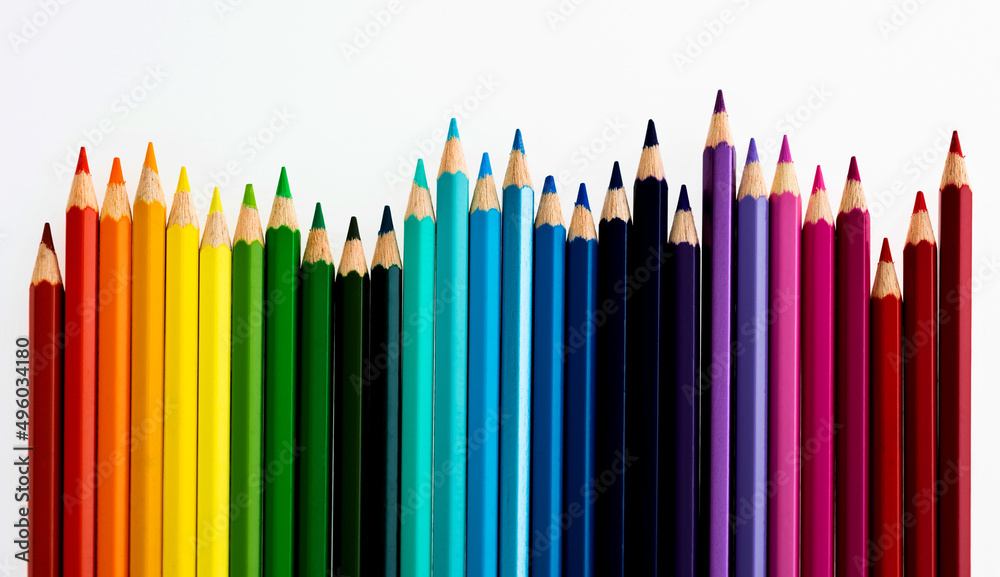 A row of colorful pencils on white background A row of colorful pencils on white background