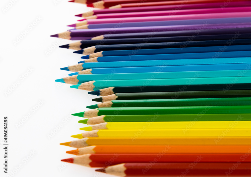 A row of colorful pencils on white background A row of colorful pencils on white background