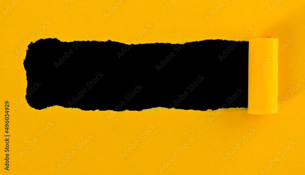 Yellow torn paper on black background Yellow torn paper on black background