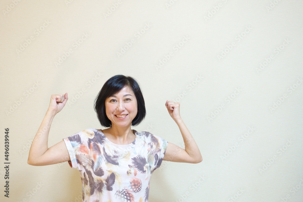元気にガッツポーズする笑顔の中年女性 元気にガッツポーズする笑顔の中年女性
