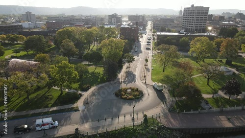 Panorama of downtown area from park, to buildings, to the Mississippi River and bridge crossing in La Crosse, Wisconsin, in summer. Hazy summer sky with bluffs seen in all directions. 