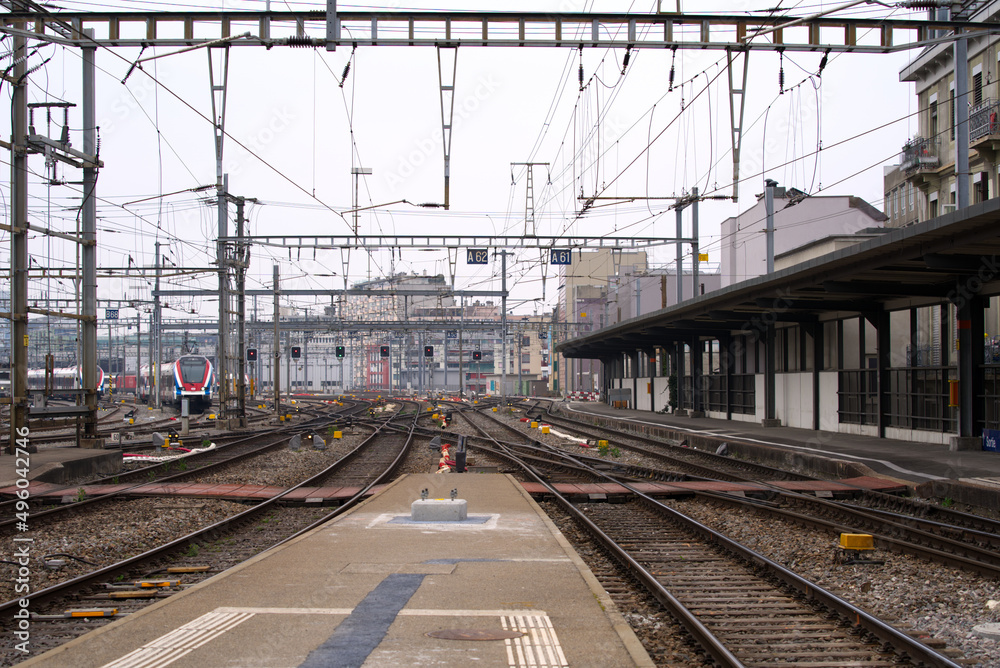 Geneva Cornavin station at City of Geneva with platform and railway signals on a cloudy spring day. Photo taken March 18th, 2022, Geneva, Switzerland.