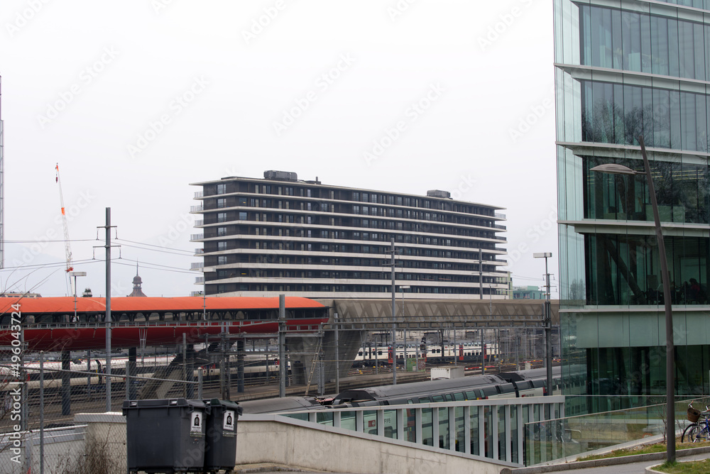 Modern red orange footbridge at Genève-Sécheron railway station on a cloudy spring day at City of Geneva, focus on foreground. Photo taken March 18th, 2022, Geneva, Switzerland. Modern red orange footbridge at Genève-Sécheron railway station on a cloudy spring day at City of Geneva, focus on foreground. Photo taken March 18th, 2022, Geneva, Switzerland.