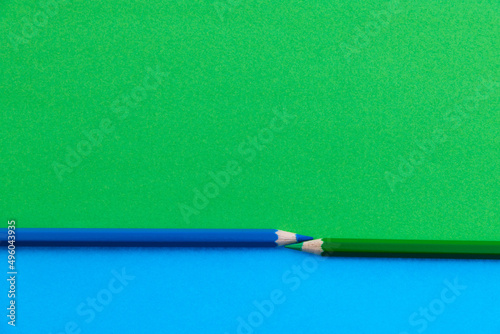 Two colored pencils divide an area into two