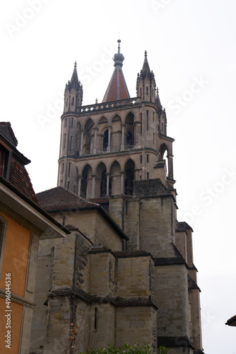 Medieval Cathedral Notre Dame at the old town of Lausanne on a blue and gray cloudy spring day. Photo taken March 18th, 2022, Lausanne, Switzerland.