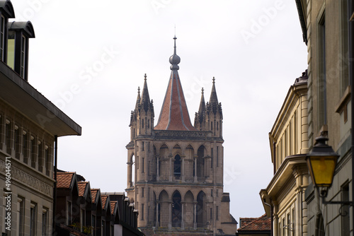 Medieval Cathedral Notre Dame at the old town of Lausanne on a blue and gray cloudy spring day. Photo taken March 18th, 2022, Lausanne, Switzerland.