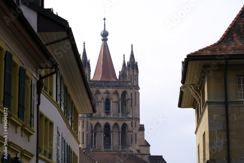 Medieval Cathedral Notre Dame at the old town of Lausanne on a blue and gray cloudy spring day. Photo taken March 18th, 2022, Lausanne, Switzerland.