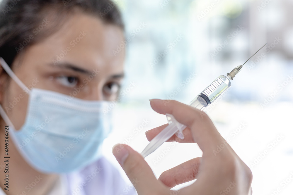Doctor holding a syringe containing a respiratory viral vaccine or anti-influenza medication, Research and covid19, Pandemia, Infectionist, Doctor holding a vaccine against COVID-19 in the hospital. Doctor holding a syringe containing a respiratory viral vaccine or anti-influenza medication, Research and covid19, Pandemia, Infectionist, Doctor holding a vaccine against COVID-19 in the hospital.