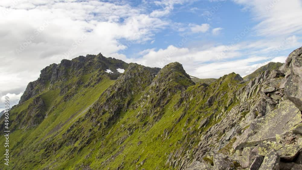 Timelapse of a mountain with clouds passing by at summer