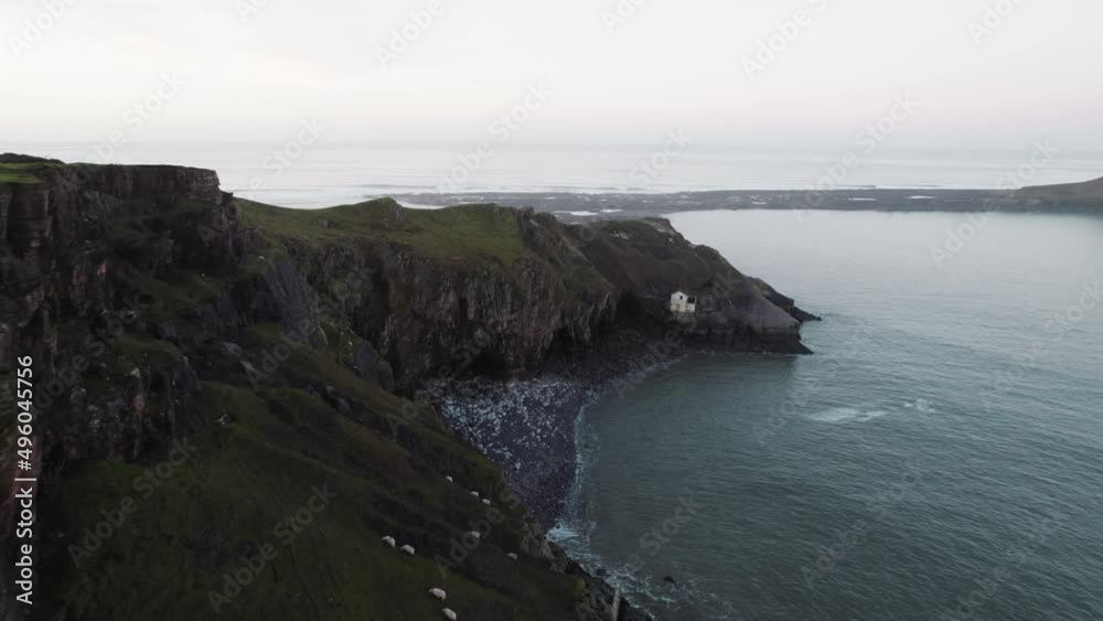 AERIAL: Fly along coastal cliffs towards abandoned boathouse, Rhossili Gower, 4k Drone AERIAL: Fly along coastal cliffs towards abandoned boathouse, Rhossili Gower, 4k Drone