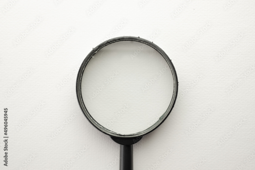 Fototapeta premium View through a magnifying glass on white background.