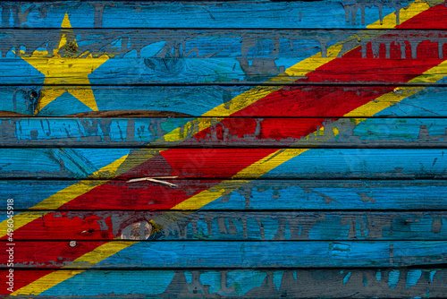 The national flag of Democratic Republic of the Congo is painted on uneven boards. Country symbol.