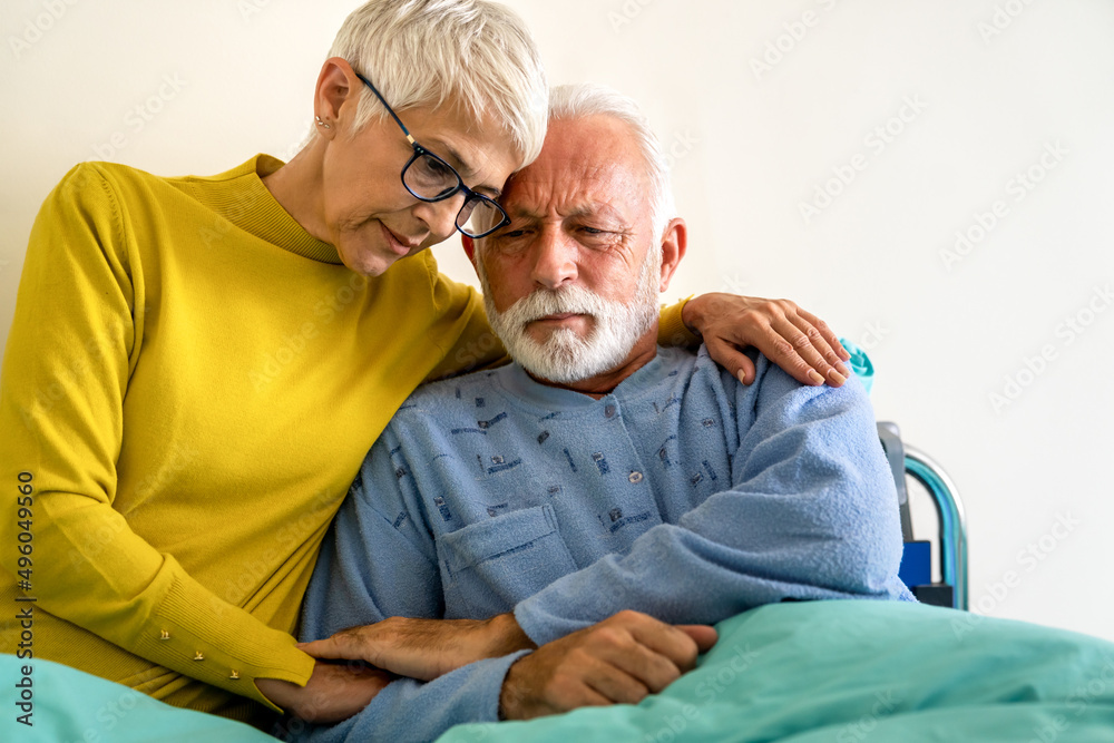 Senior woman with seriously ill husband in hospital. Healthcare support anxiety love concept - obrazy, fototapety, plakaty 