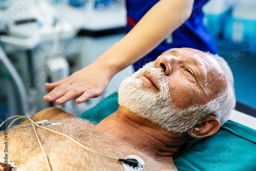 ECG electrodes on mature male patient in hospital before surgery. Healthcare and medicine concept photo