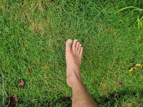 Photo of human feet on green grass photo