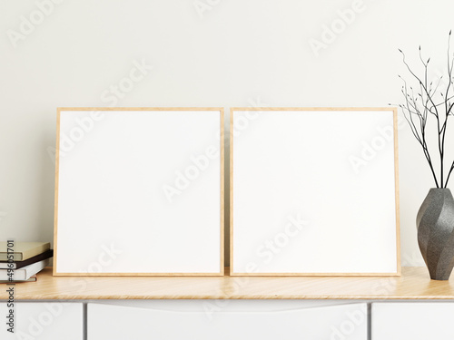 Minimalist square wood poster or photo frame mockup on wood table with books and vase in a room