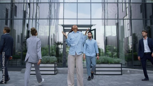 Successful corporate worker celebrating triumph laughing in urbanistic workplace photo