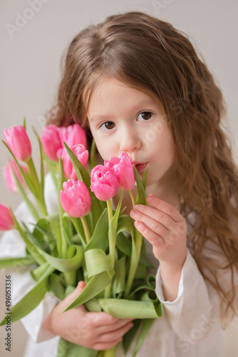 little girl with pink tulips