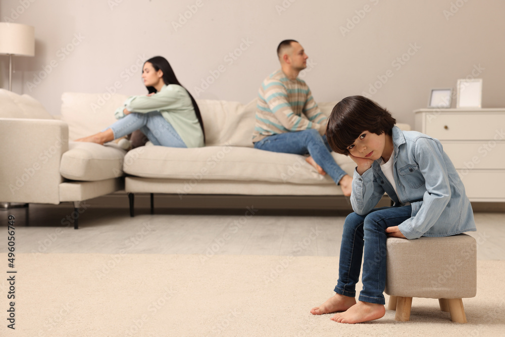 Sad couple with relationship problems at home, focus on their upset child Sad couple with relationship problems at home, focus on their upset child