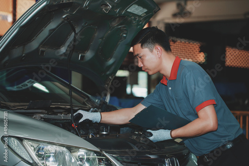 Auto mechanic, car repair service center, young mechanic checking cars, concept of a comprehensive car repair service center.