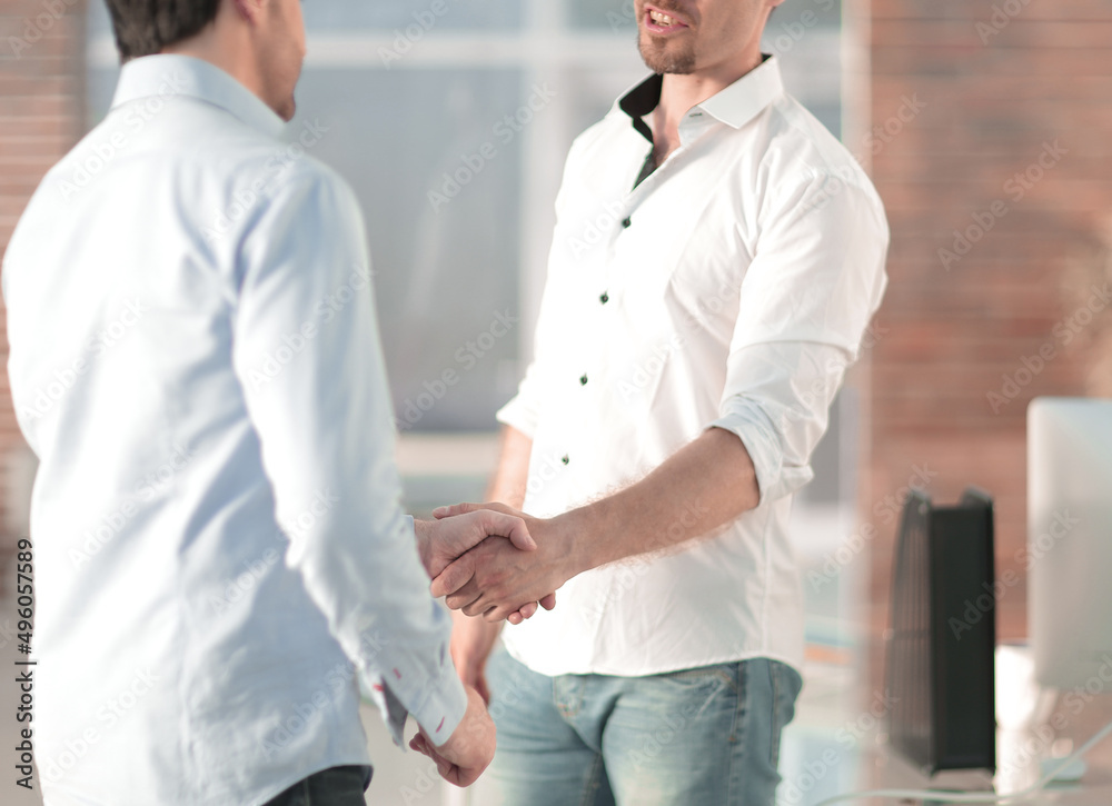 handshake of business people standing in a creative office handshake of business people standing in a creative office
