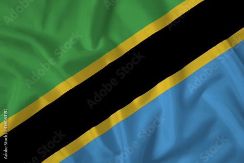 Tanzania flag with fabric texture. Close up shot, background