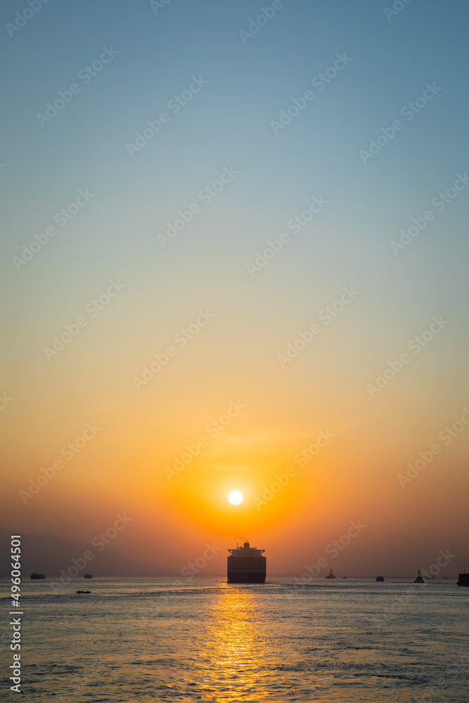 Cargo Carrier sailing in ocean, sunset moment