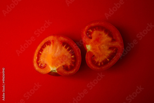 Red tomato on a red background © Tetiana Romaniuk