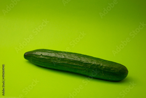 Green cucumber on a green background