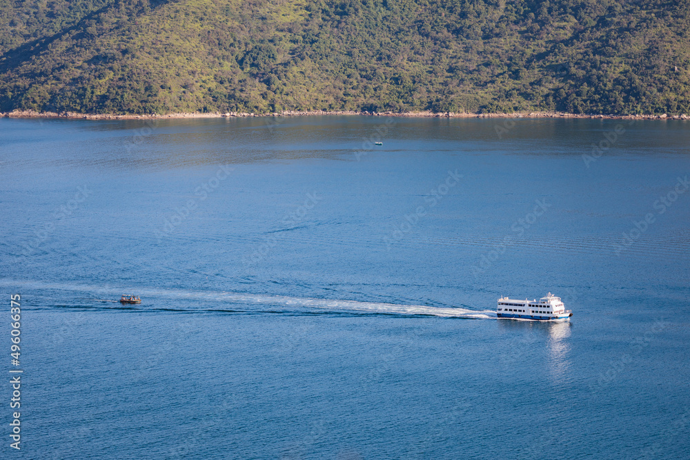Obraz premium Ferry sailing across coastline, sea near Tolo Channel, Hong Kong