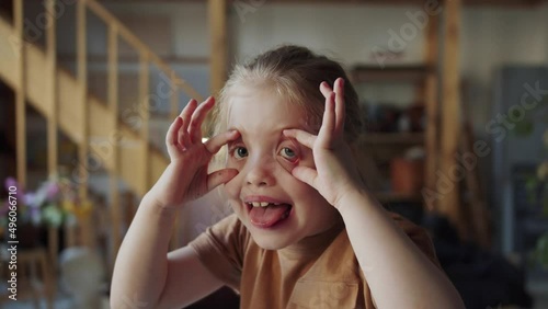 Teen girl makes ugly faces and grimaces at the camera