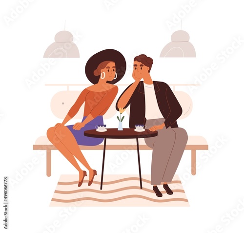 Love couple in cafe on date. Happy woman and charmed man sitting at table wit...