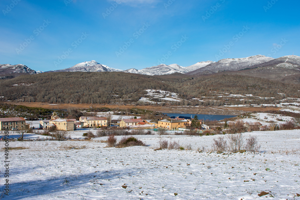 snowy mountain landscape with lake and village