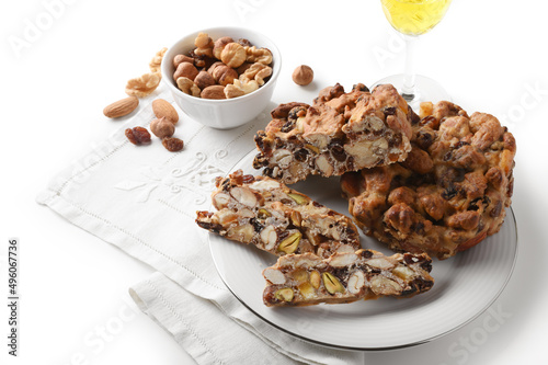 Pangiallo, traditional Italian dessert with honey, candied fruit, flour and dried fruit, isolated on white background.