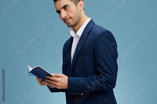 handsome man with an open notebook in hand a business plan official isolated background Copy space