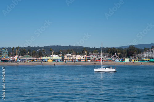 Santa Cruz Beach seen from Santa Cruz Wharf with a white yacht