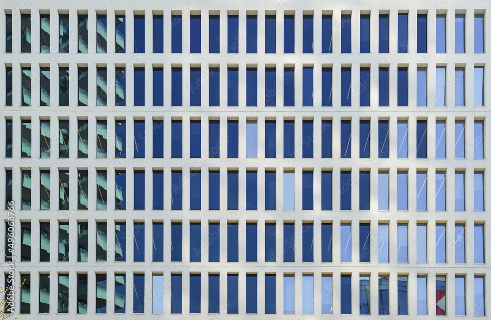 full frame shot of the symmetrical facade of an office building full frame shot of the symmetrical facade of an office building