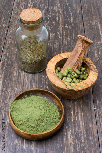 supergreens powder and green beans in a mortar and whisk. Healthy food concept.