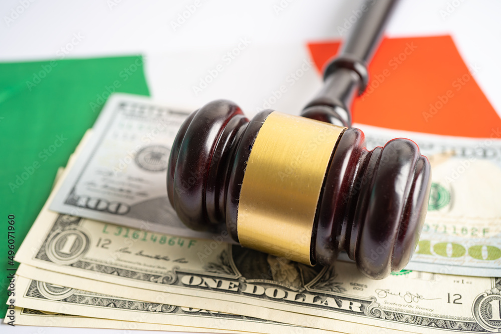 Gavel for judge lawyer and US dollar banknotes on Italy flag, finance concept. Gavel for judge lawyer and US dollar banknotes on Italy flag, finance concept.