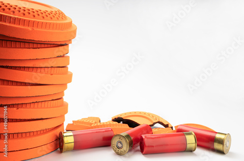 Flying clay pigeon target with shot gun bullet shell on white background , Gun shooting game photo