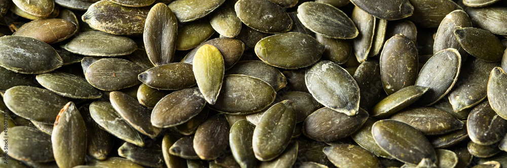 Roasted pumpkin seeds background, close up Roasted pumpkin seeds background, close up