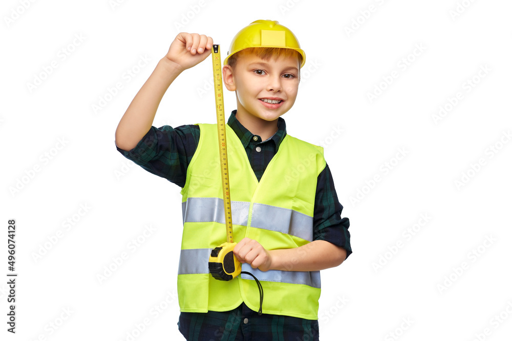 building, construction and profession concept - happy smiling little boy in protective helmet and safety vest with ruler over white background building, construction and profession concept - happy smiling little boy in protective helmet and safety vest with ruler over white background