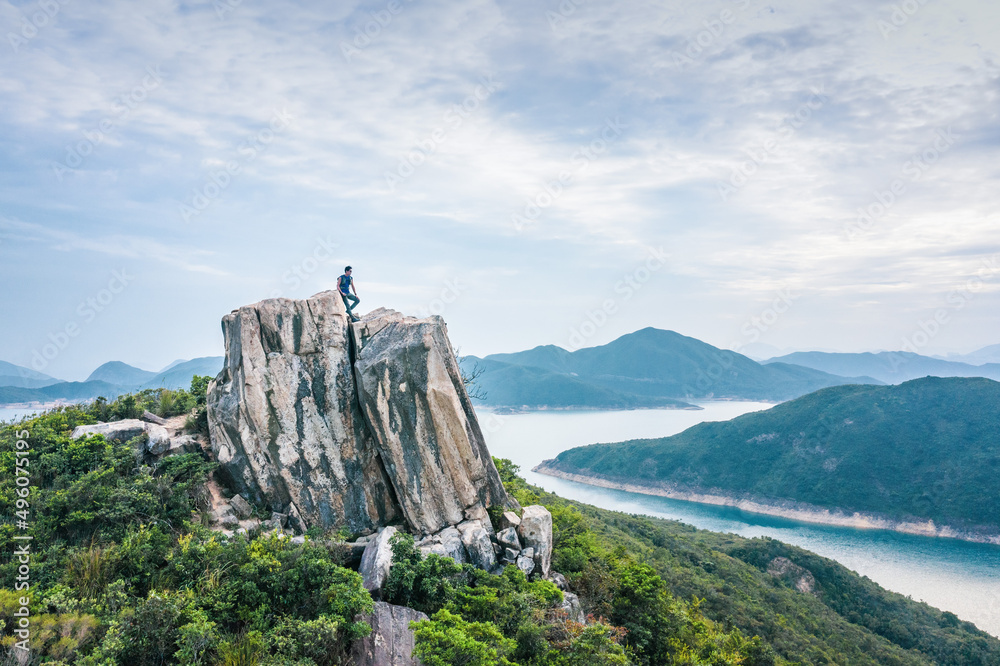 Obraz premium Hiking man alsone on Amazing view of High Island Reservoir, Countryside Park, Sai Kung, Hong Kong, daytime