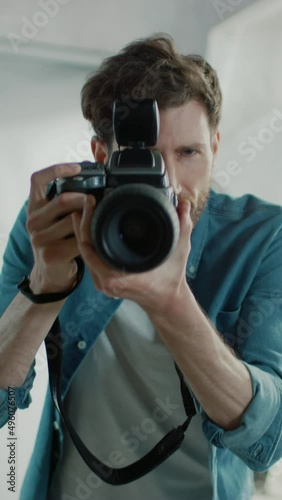 Portrait of the Handsome Photographer Holding State of the Art Camera Ready to Take Pictures with Softboxes Lighting in Background. Vertical Screen Orientation Video