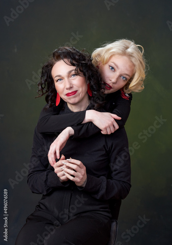 Portrait of beautiful mother daughter possing in a studio