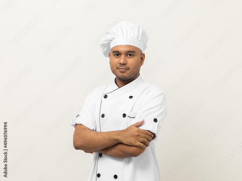 Smiling Young handsome asian man chef in uniform with hat standing posting looking at camera on isolated white background. Cooking man Occupation chef or baker People in kitchen restaurant and hotel. Smiling Young handsome asian man chef in uniform with hat standing posting looking at camera on isolated white background. Cooking man Occupation chef or baker People in kitchen restaurant and hotel.