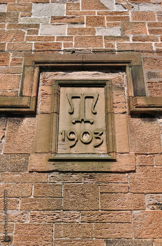 Close Up of Carved Stone Date Plaque on Old 20th century Building  © eyepals
