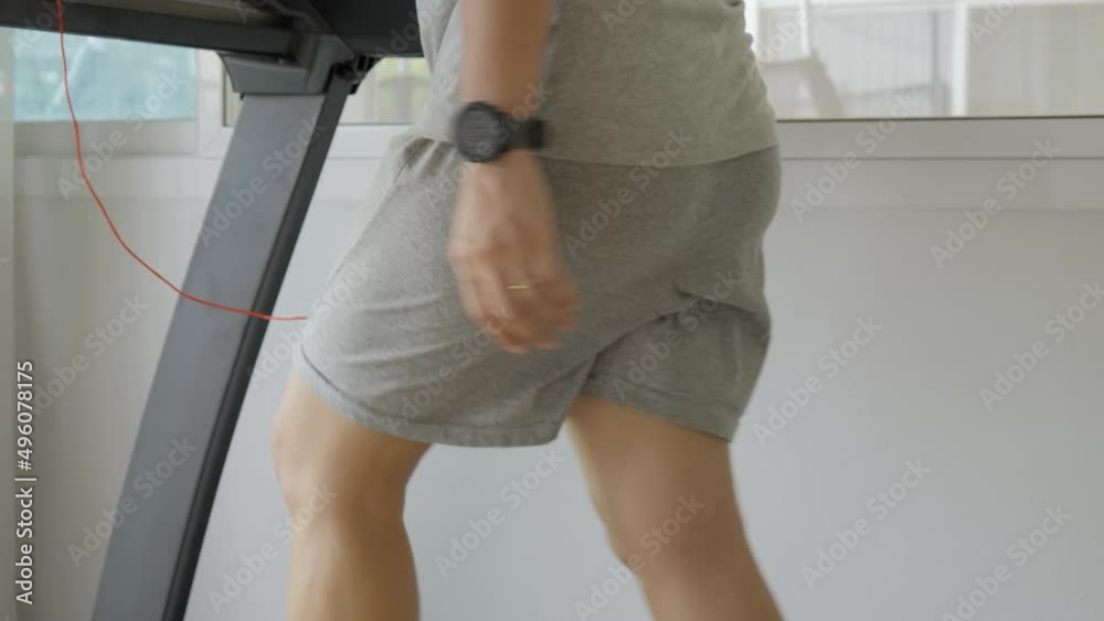 Woman with bouncing big hip or buttom doing the exercise on the treadmill at home.